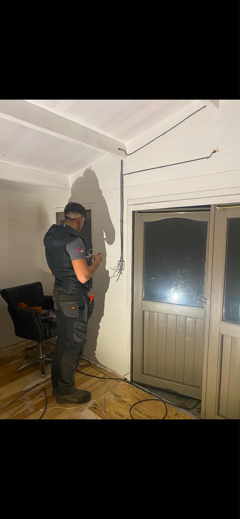 Electrician installing wiring and cables in residential interior