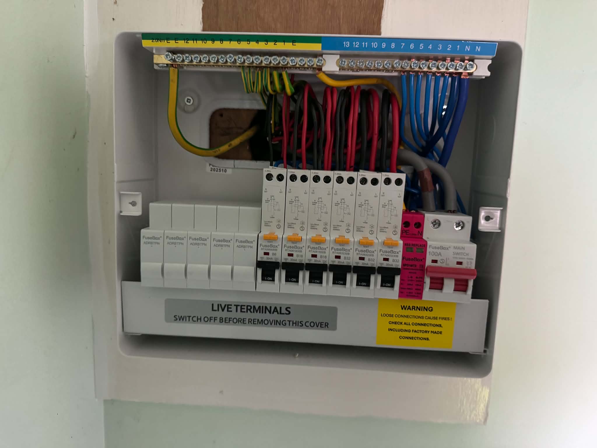 Open consumer unit with organized wiring and circuit breakers installed